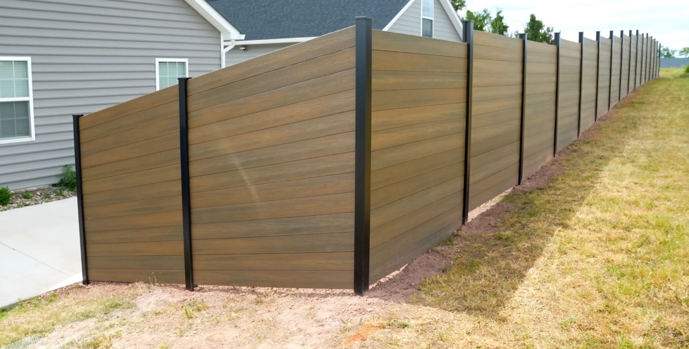 Modern composite fence on sloped property in Quincy, IL